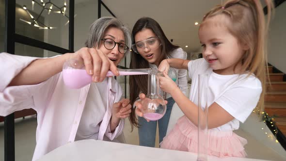 Family Doing Chemical Experiment Mixing Flasks Indoors alt