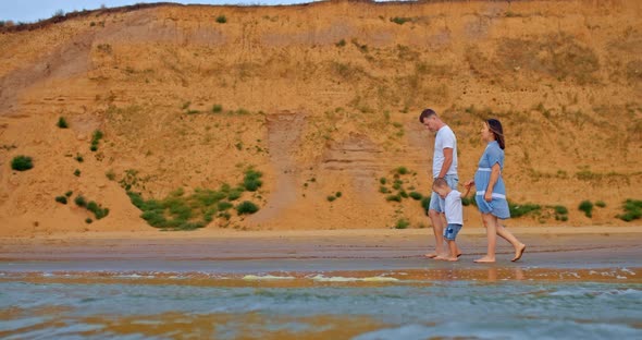 Beautiful Family Walks Along the Shore Bare Feet Walking on the Sand