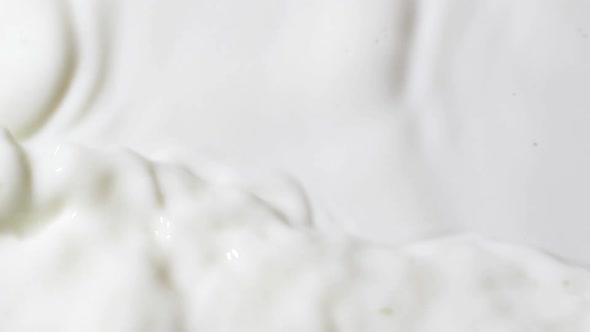 Slow Motion White Liquid Cream Ripples Closeup Fresh Milk Drink Splash Texture