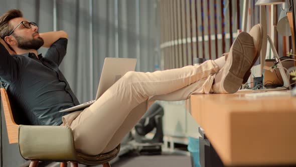 Thoughtful Serious Man Sitting On Workplace And Meditate Relieve Stress. Stress Free Man Relaxing. alt
