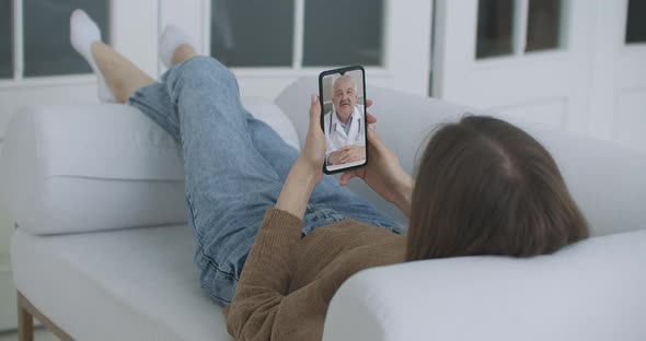 Woman Using Smartphone To Talk To His Doctor Via Video Conference Medical App. Person Checks alt