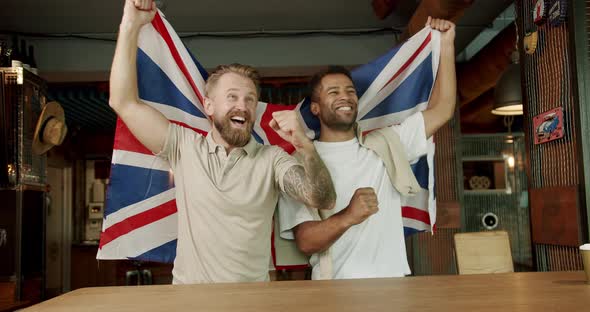 Fans Watching Football in a Bar with Friends alt