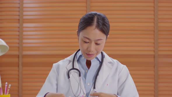 Camera view Asian doctor woman meeting online with pregnant patient to consult alt