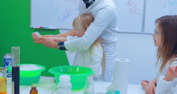 Teacher Teaching Group of Students in School Science Class alt