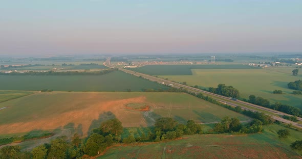 Panorama Landscape View in Sunrise Over the Meadow Across High Speed Highway in the Morning Fog in alt