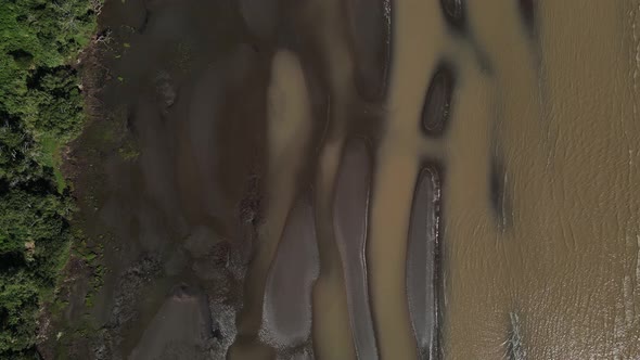 Overhead aerial push-in of sandbanks, shallow water by Rio de la Plata alt