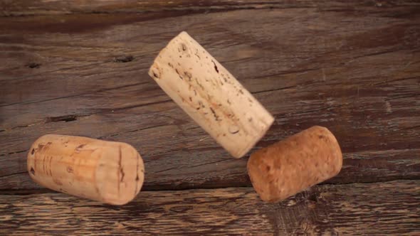 Falling wine corks on old wooden vintage boards. Slow motion. alt