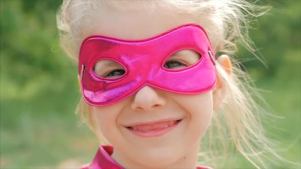 Beautiful Llittle Girl in the Superhero Costume, Close Up Portrait Child in the Mask of the Hero alt