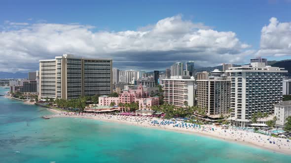 Wide push-in aerial shot of beautiful Waikiki Beach on the island of O'ahu, Hawaii. 4K alt