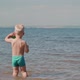 Carefree boy play on the beach in the water. - VideoHive Item for Sale