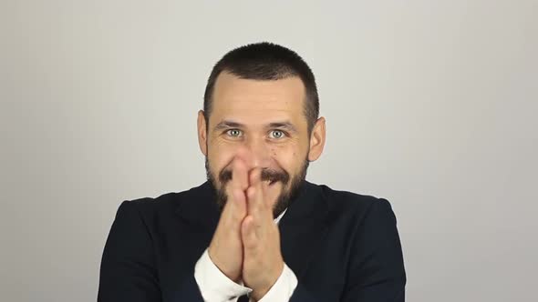 Young Handsome Businessman Is Smiling and Rubbing His Hands alt
