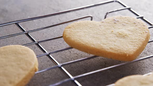 Raw heart shape cookies with sugar icing on baking tray alt