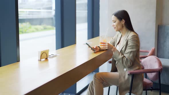 Business Woman with Orange Juice in Cafe