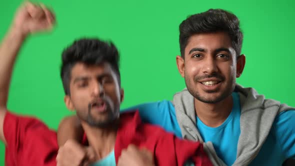 Front View Excited Middle Eastern Football Fans Gesturing Rejoicing Victory on Green Screen alt
