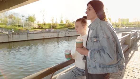 Woman with Coffee on Bridge