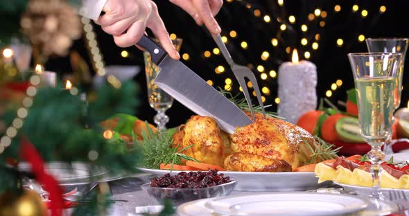 Woman Carving Roasted Chicken on Christmas Dinner