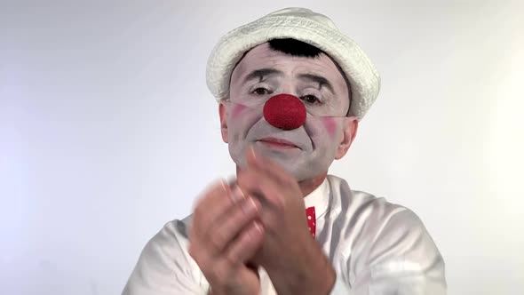 Emoji clown - Disappointed Face. A sad mime clown with a frowning mouth and disappointed eyes throws alt