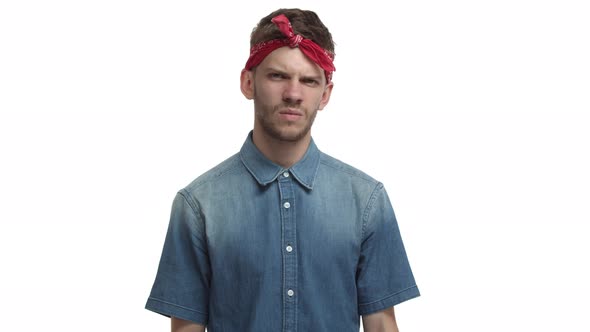 Video of Handsome Young Hipster Guy with Red Bandana Grimacing Reacting to Something Strange or