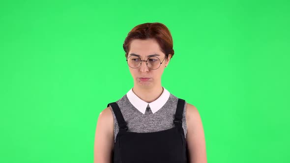 Portrait of Funny Girl in Round Glasses Is Very Offended and Looking Away. Green Screen alt