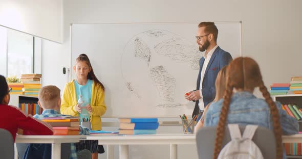 Preteen Girl Student Having Presentation in Classroom About Waste Separation alt