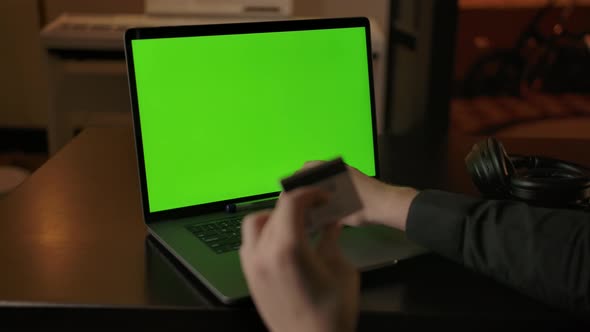 Dolly in Shot of Chromakeyed Laptop Screen and Man's Hands with Credit Card alt