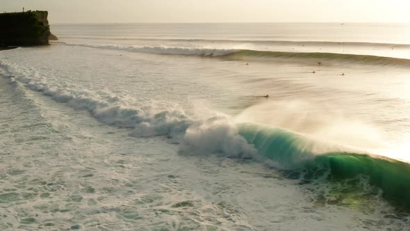 Following large waves at sunset