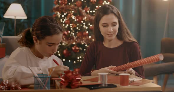 Sisters preparing Christmas gifts together
