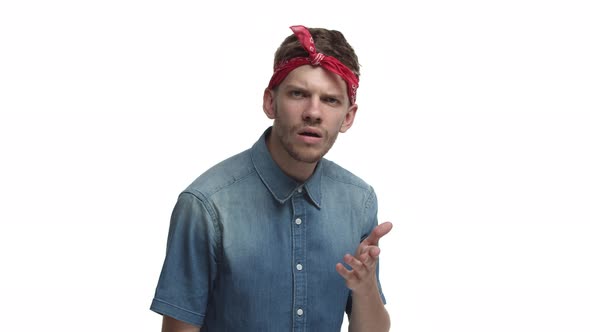 Handsome Bearded Male Hipster in Red Bandana Looking Confused at Camera Cant Understand Something