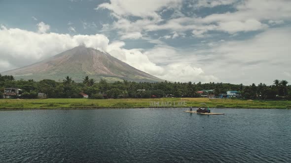 Mayon Volcano at Lake Shore Aerial. Tourist at Boat Sail To Green Grass ...