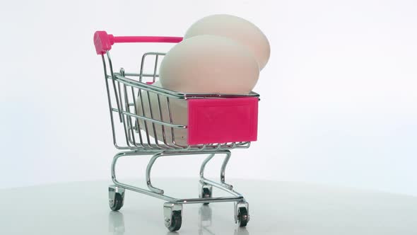 White Chicken Eggs In A Trolley From A Supermarket, Natural Chicken Eggs Are Spinning alt