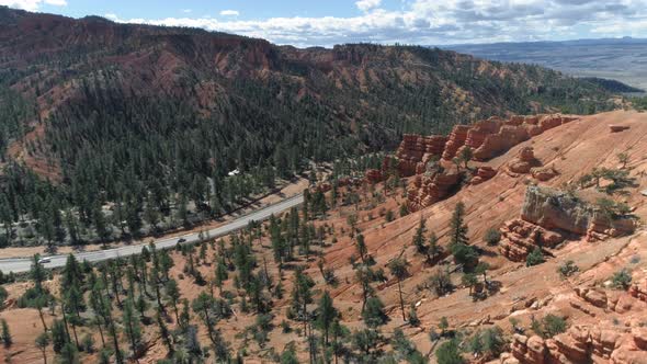  Aerial Over Beautiful Red Rock Formations and Road. Bryce Canyon, Utah, USA alt