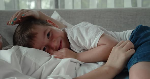 A Happy Family of Two Mothers and a Son Resting Together on the Couch These Preschoolers Sleep on alt