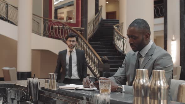 Coworkers Meeting by Bar Counter alt