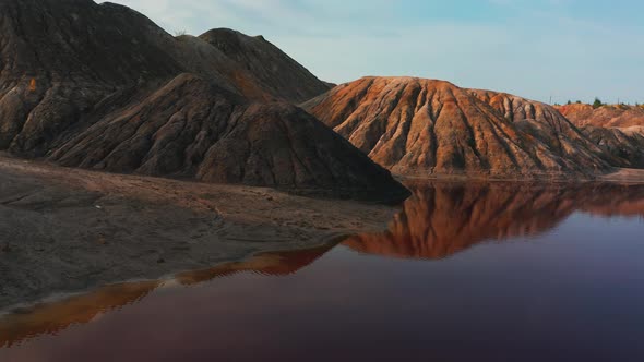 Aerial View of a Landscape Similar To the Planet Mars with Red Hills and Rivers with Red Water alt