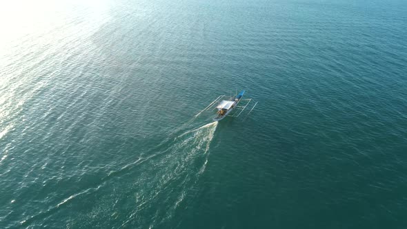 Drone View a Traditional Bangka Boat Floating in the Open Ocean on the Sunset Palawan Philippines alt