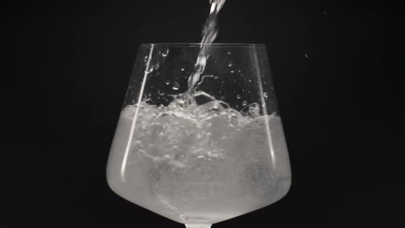 Sparkling Water Pouring Ice Glass Closeup Slow Motion alt