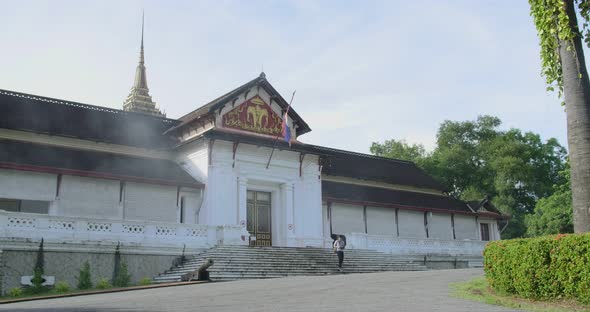 Man Walking Out Luang Prabang National Museum alt
