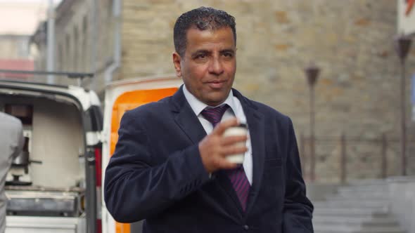 Arab Businessman Enjoying Takeaway Coffee from Street Van alt