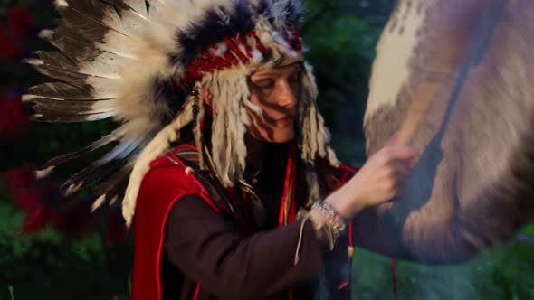 Shaman Woman Drumming at Night in The Forest
