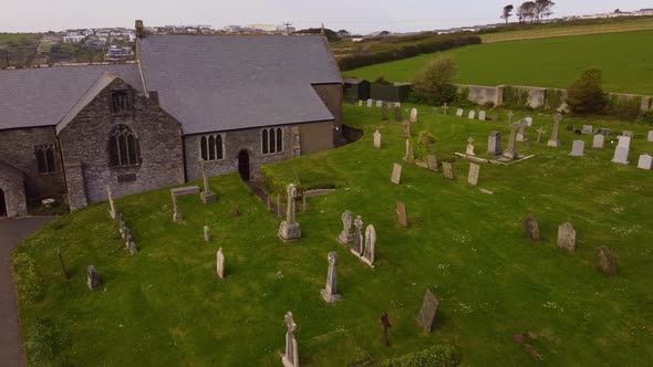 Aerial swoop across Crantock churchyard Cemetery graveyard alt