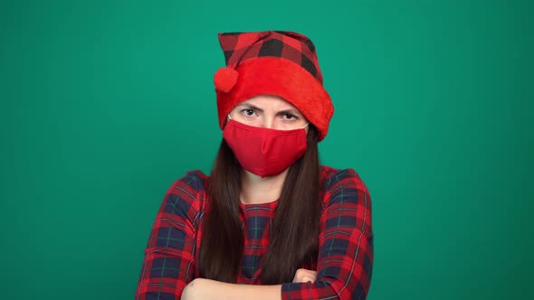 Sad Woman In Coronavirus Mask And Santa Hat