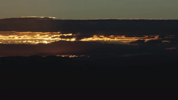 Golden Sunrise Behind Thin Layer of Clouds Timelapse Wide Shot