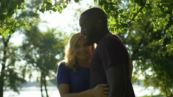 All in Love Mixed Race Couple Embrace and Look at Camera, Togetherness Concept alt