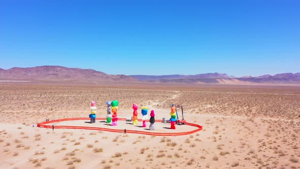 Far away counter clockwise aerial drone view of the 7 magic mountains in Nevada. alt