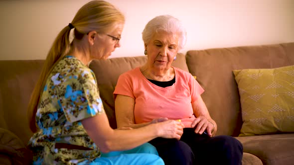 Measurement of the pulse on elderly woman. Placed on the finger heart rate monitor. alt