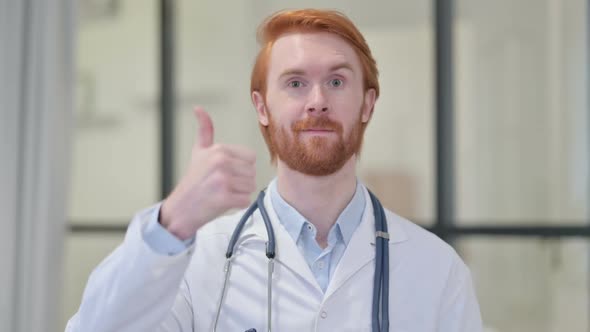 Thumbs Up Sign By Redhead Male Doctor alt