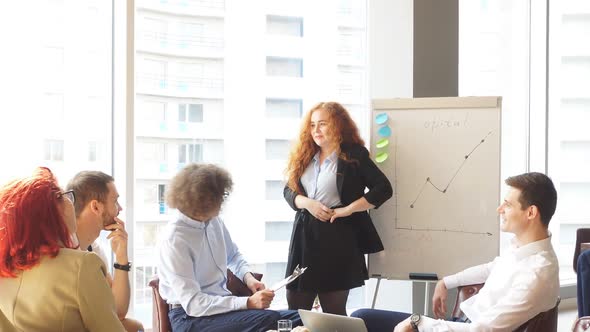 Female Boss Debating with Employees During Efficiency Charts Presentation alt