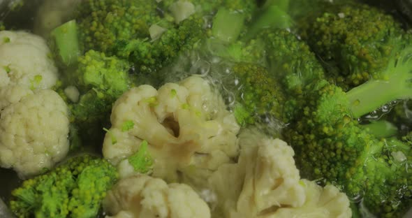 Cooking Colorful Broccoli and Cauliflower in the Pan with Boiling Water alt