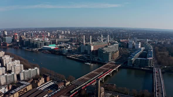 High circling drone shot around Battersea Power station on a beautiful sunny day alt