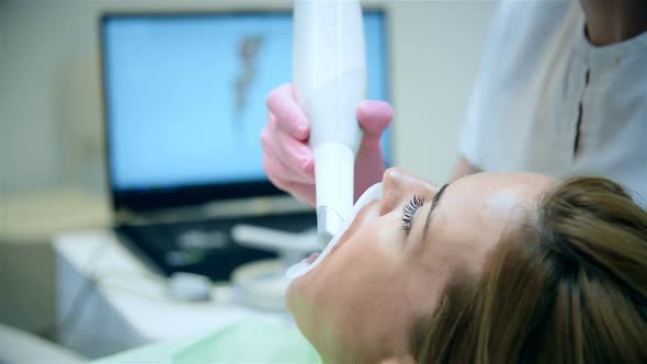 Dentist Scaning Patient's Teeth With A 3d Scanner.